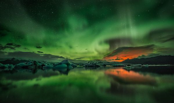 Aurora And Volcanic Eruption Over Ice Lagoon